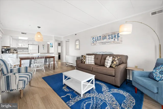 a view of a living room kitchen and a wooden floor