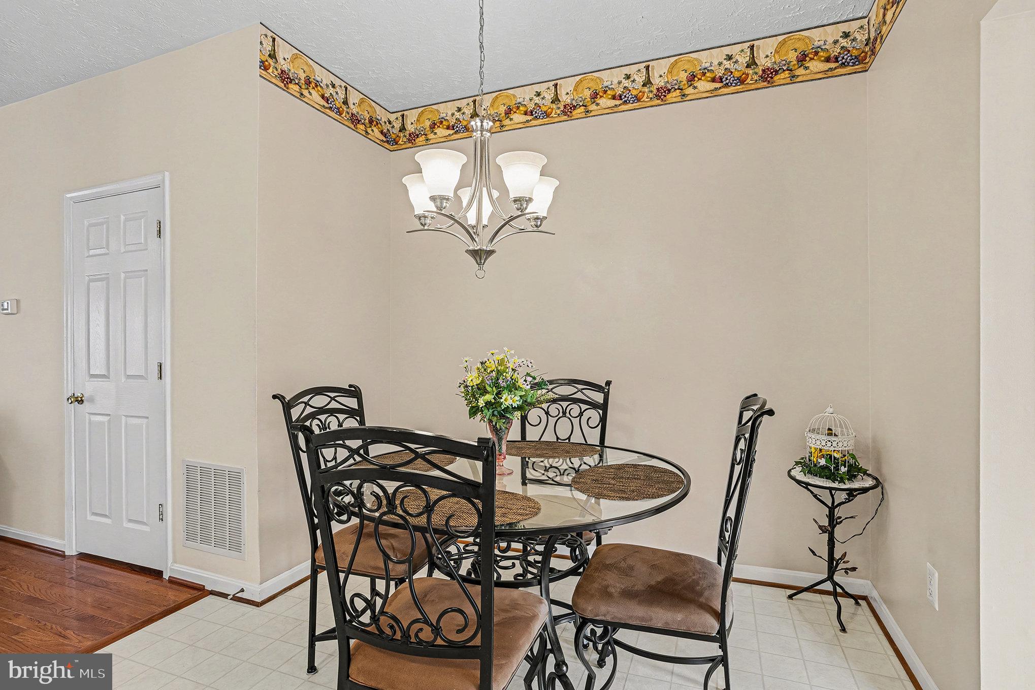 22 Oaksylvan Way Baltimore, MD 21236 - Photo 11 of 39 a view of a dining room with furniture and chandelier