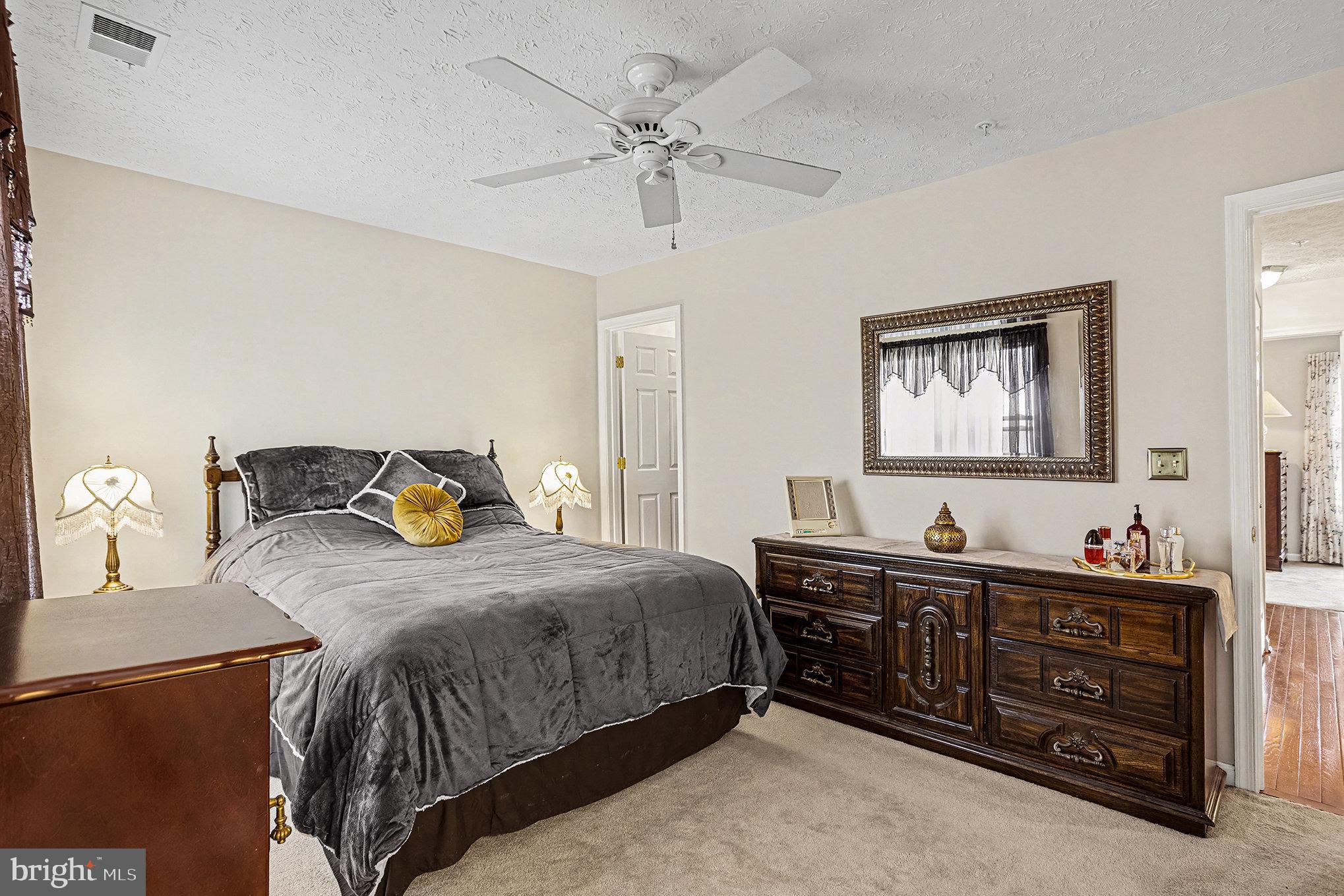 22 Oaksylvan Way Baltimore, MD 21236 - Photo 14 of 39 a bedroom with a bed dresser and wooden floor