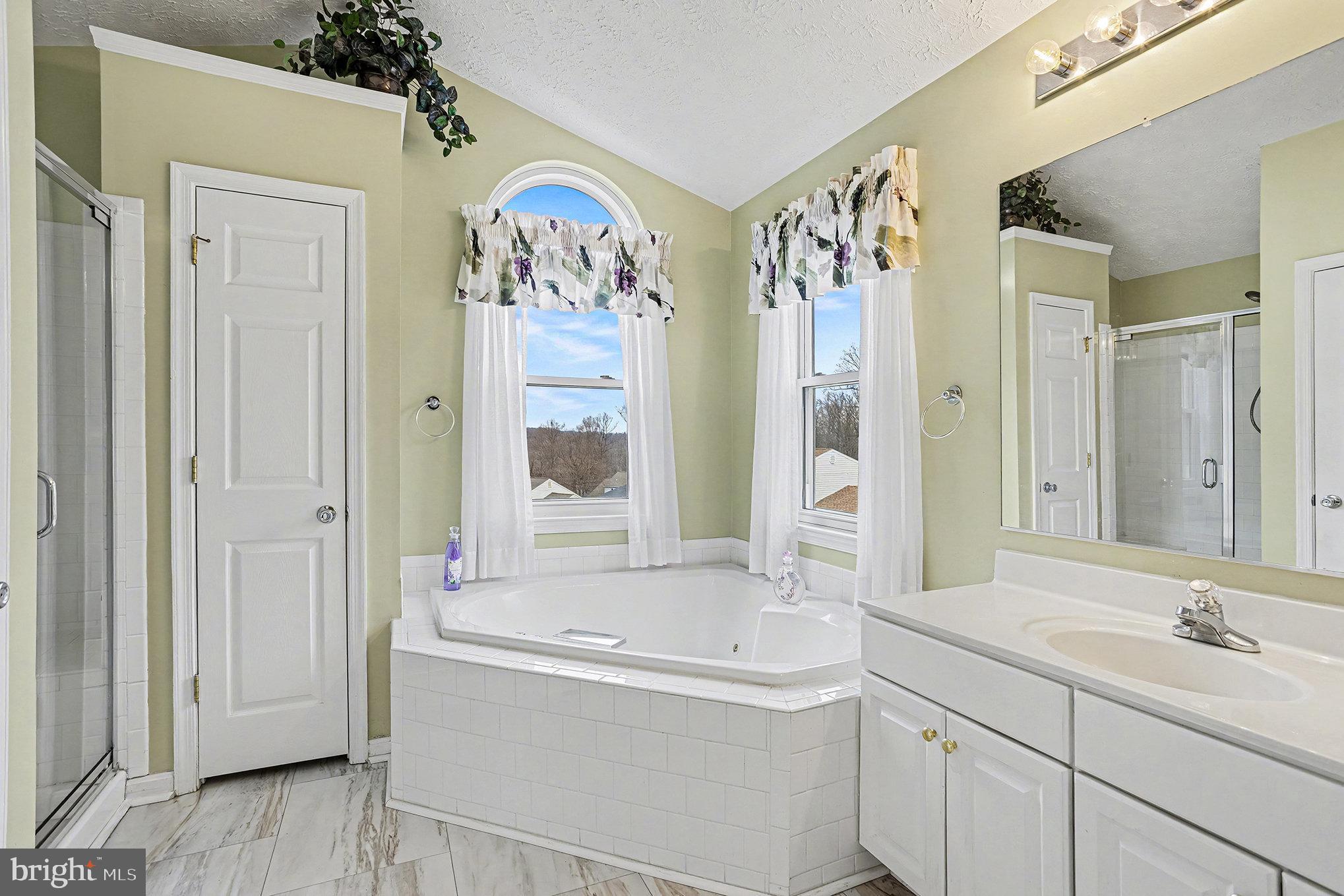 22 Oaksylvan Way Baltimore, MD 21236 - Photo 18 of 39 a bathroom with a tub sink and mirror