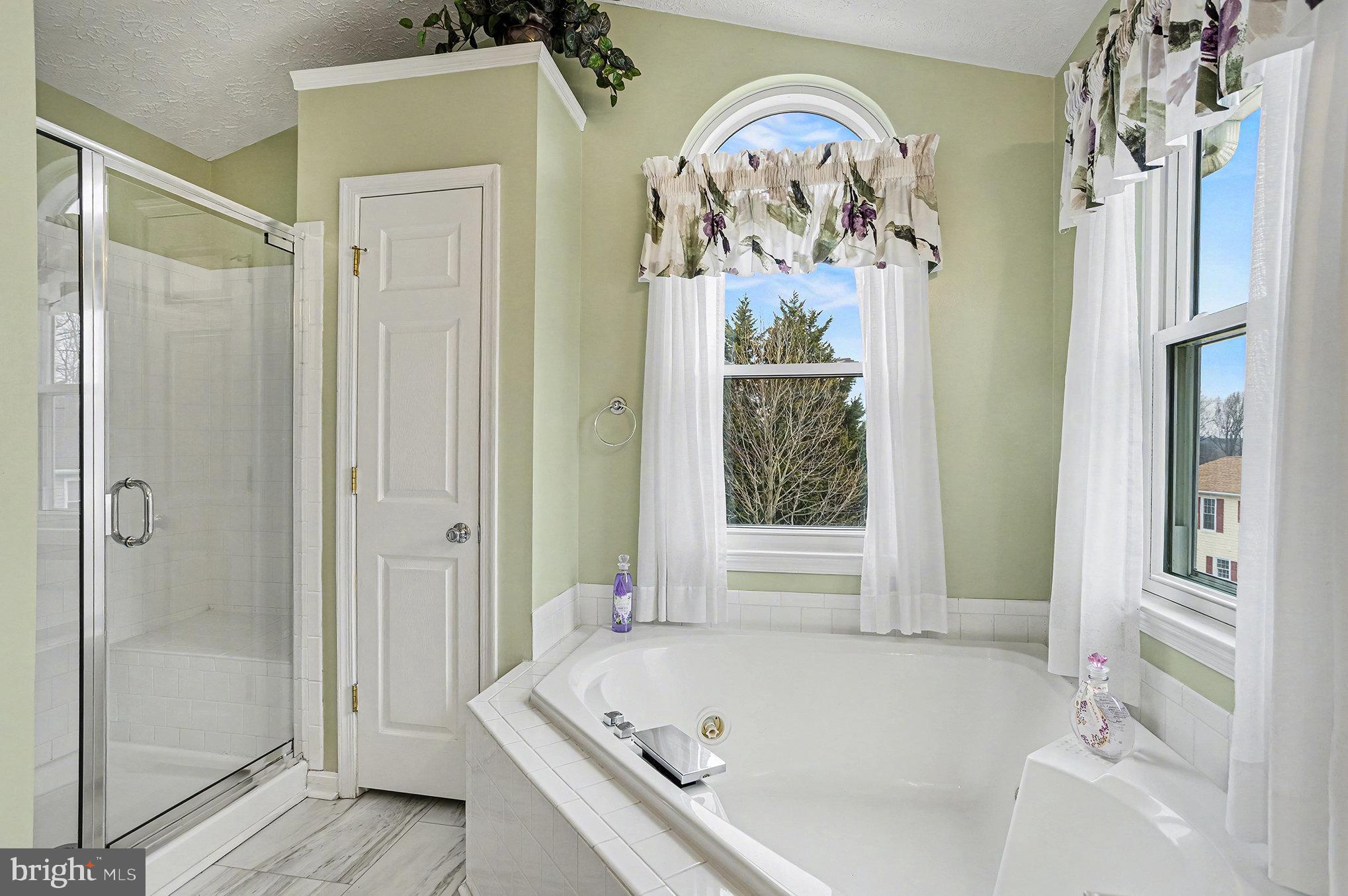 22 Oaksylvan Way Baltimore, MD 21236 - Photo 19 of 39 a bathroom with a bathtub and shower