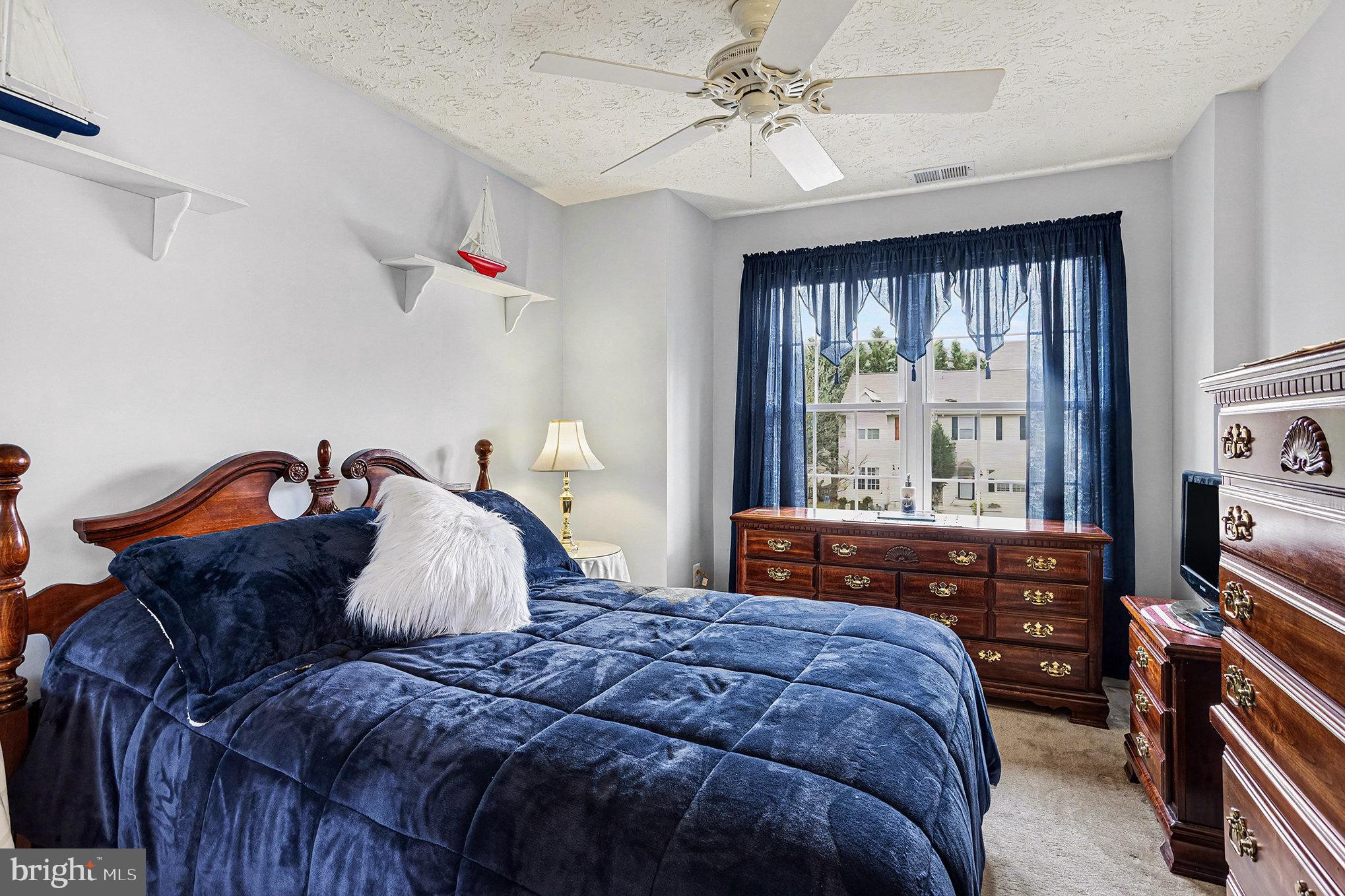 22 Oaksylvan Way Baltimore, MD 21236 - Photo 20 of 39 a bedroom with a bed and wooden floor