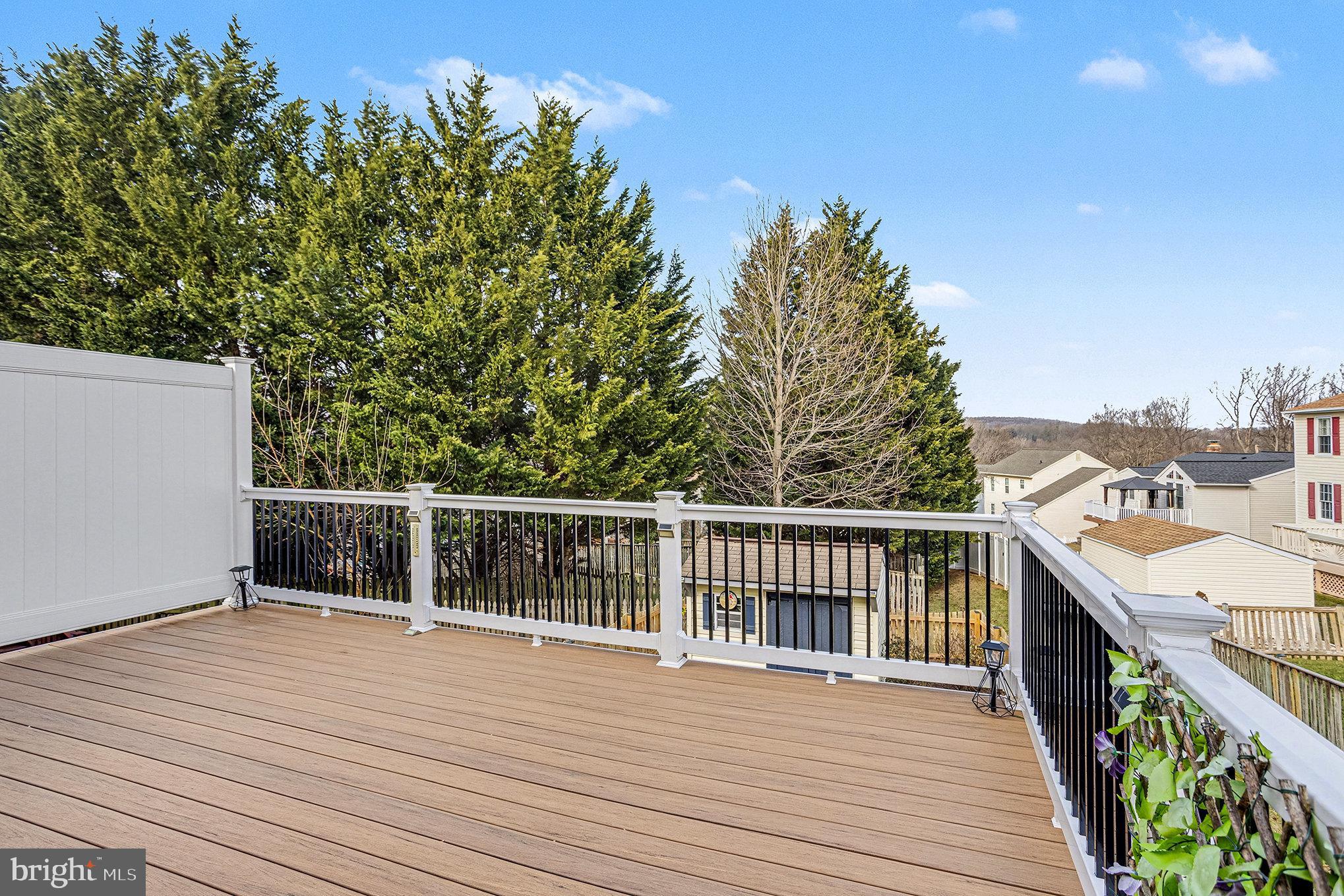 22 Oaksylvan Way Baltimore, MD 21236 - Photo 26 of 39 a view of a balcony with wooden floor and fence
