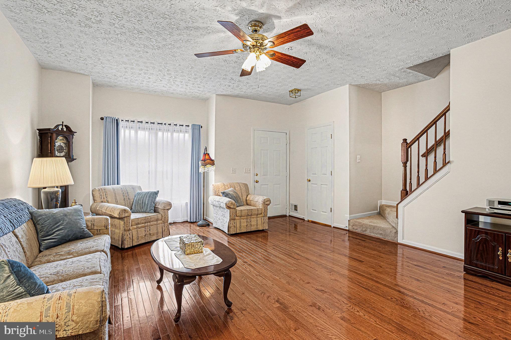 22 Oaksylvan Way Baltimore, MD 21236 - Photo 5 of 39 a living room with furniture and a wooden floor