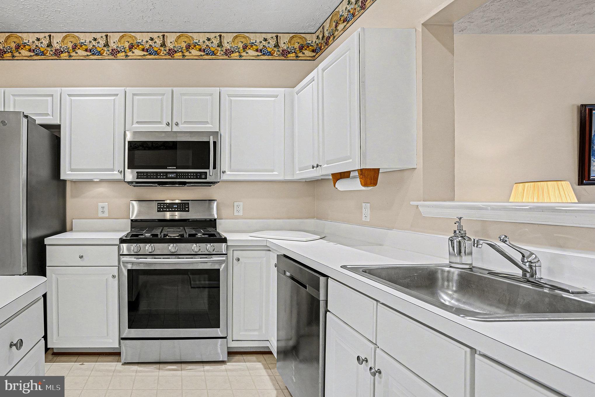 22 Oaksylvan Way Baltimore, MD 21236 - Photo 7 of 39 a kitchen with stainless steel appliances granite countertop a sink a stove a microwave and cabinets