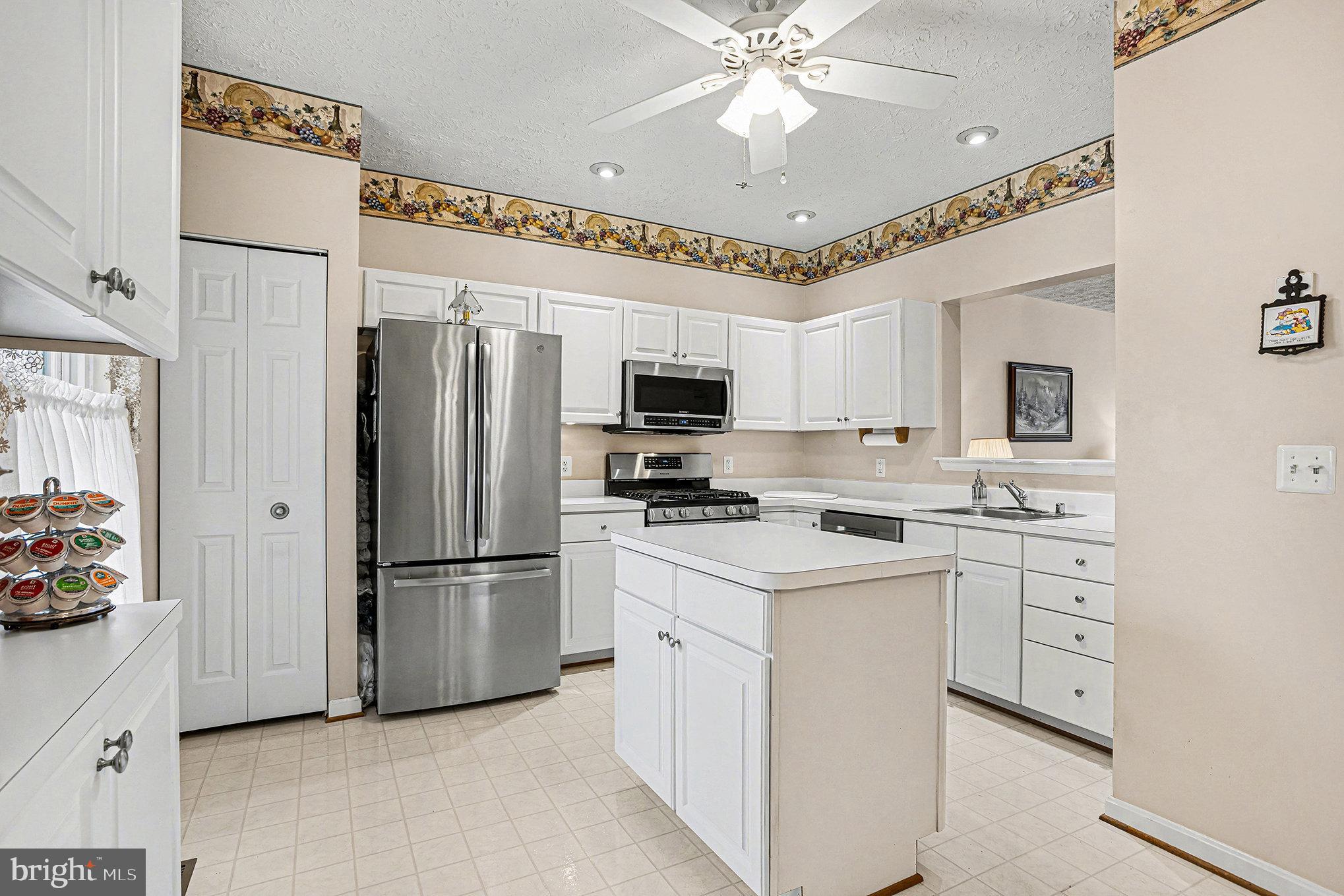 22 Oaksylvan Way Baltimore, MD 21236 - Photo 9 of 39 a kitchen with white cabinets and stainless steel appliances