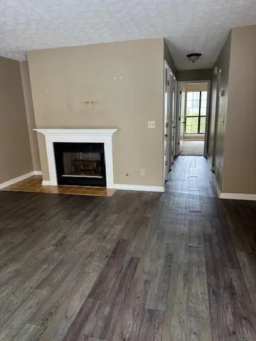 a kitchen with a sink cabinets and wooden floor