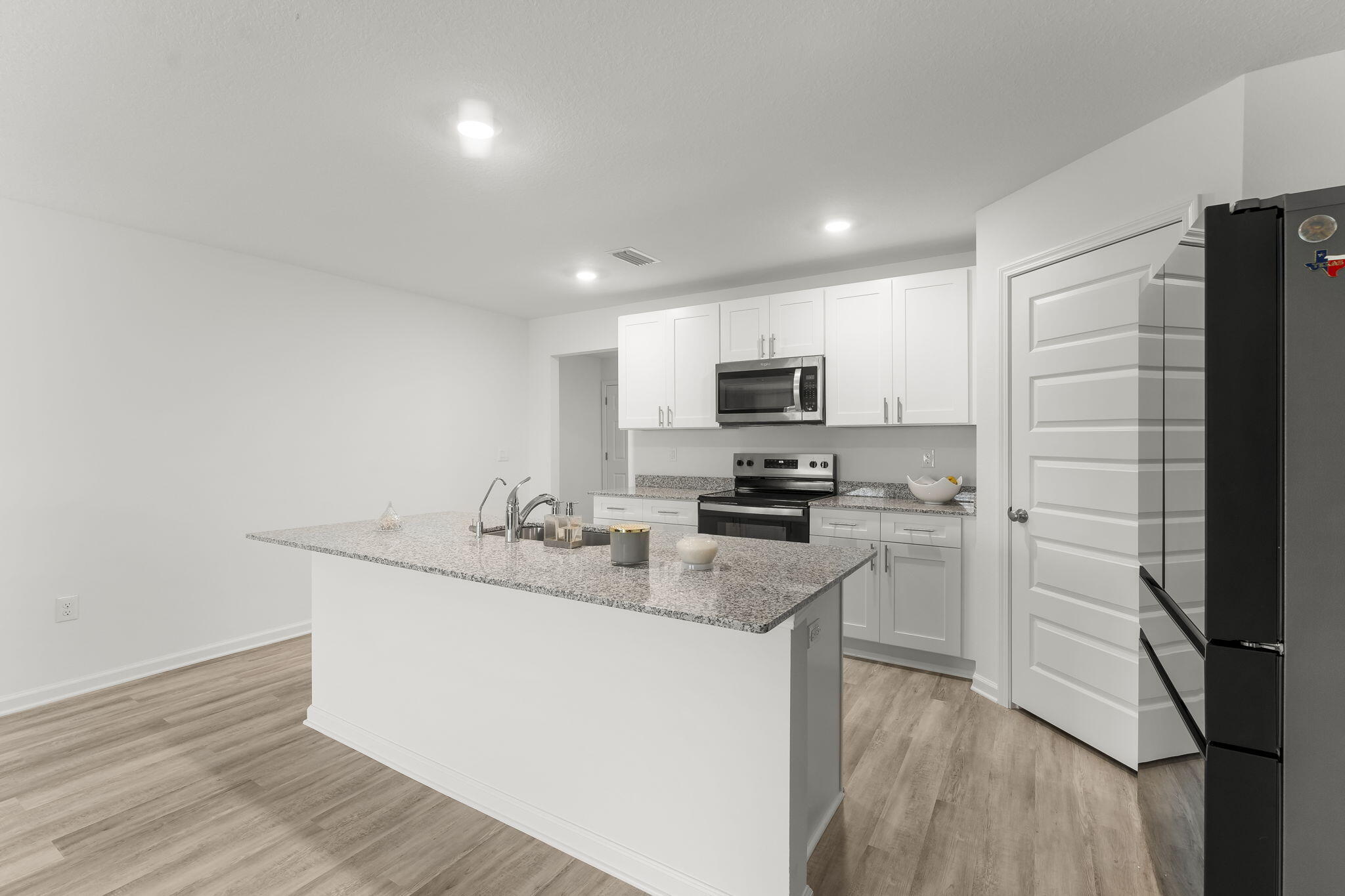 255 Riverwalk Circle Freeport, FL 32439 - Photo 4 of 40 a kitchen with a sink stainless steel appliances and cabinets