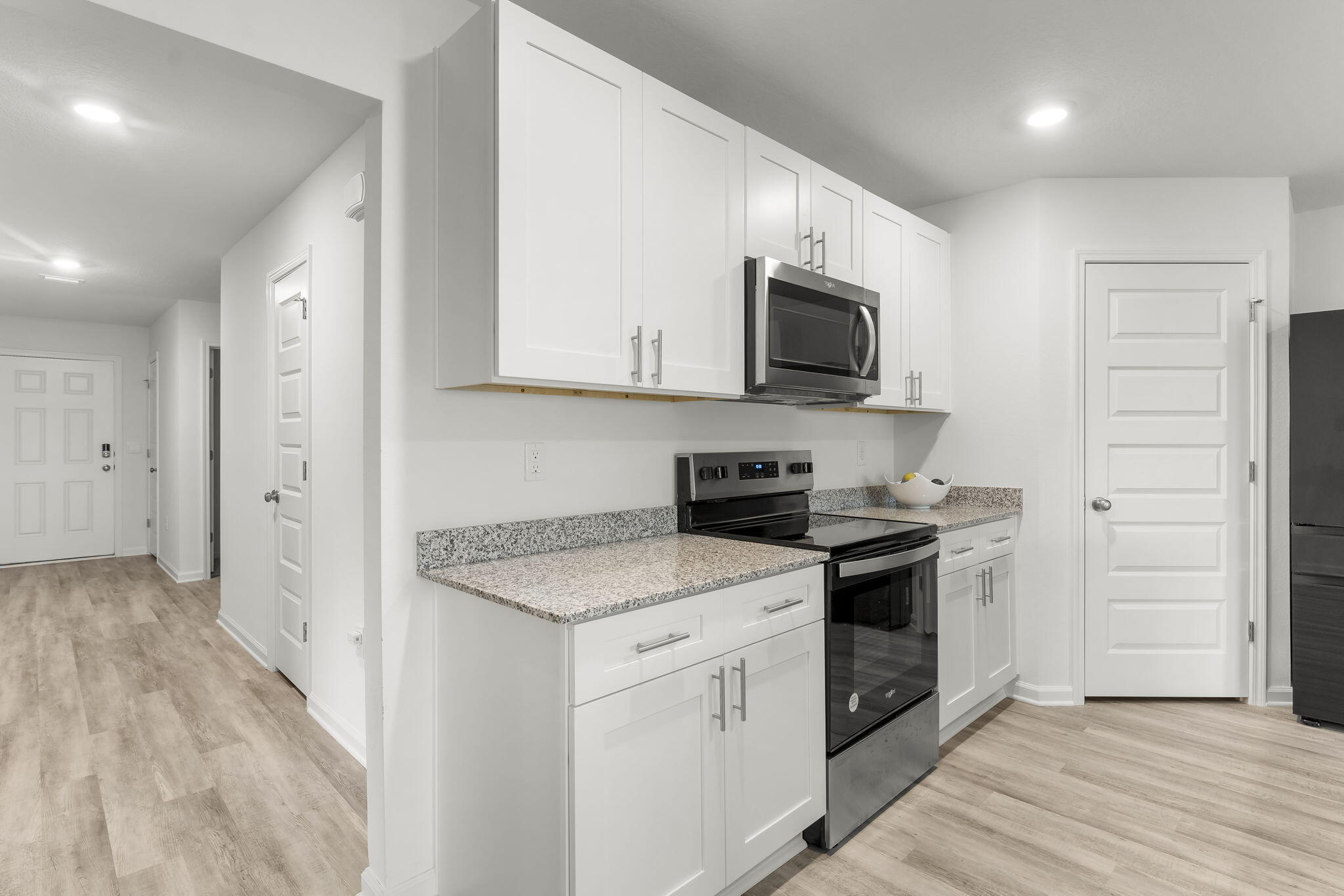 255 Riverwalk Circle Freeport, FL 32439 - Photo 7 of 40 a kitchen with a stove and a microwave