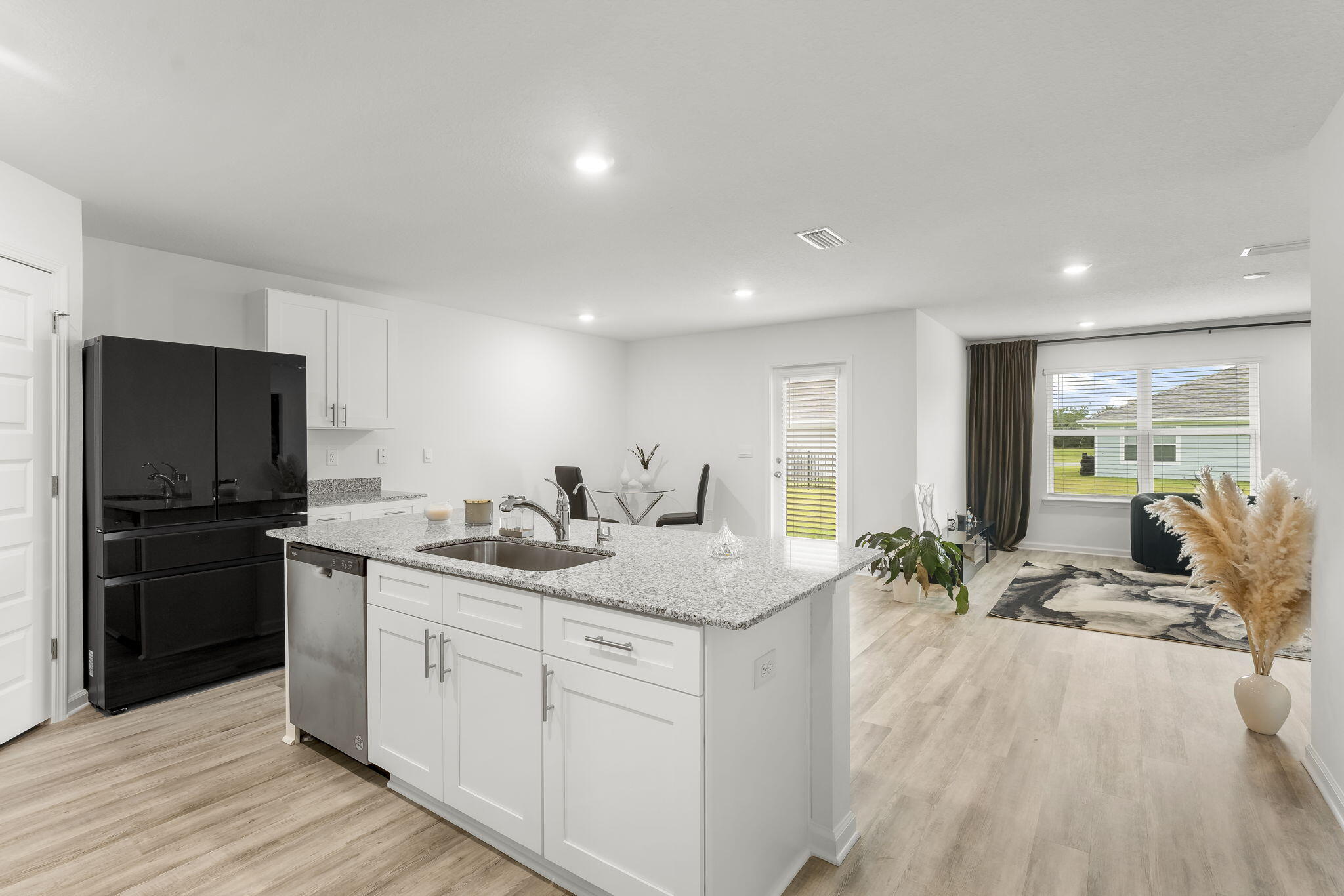 255 Riverwalk Circle Freeport, FL 32439 - Photo 10 of 40 a kitchen with stainless steel appliances granite countertop a sink stove and refrigerator