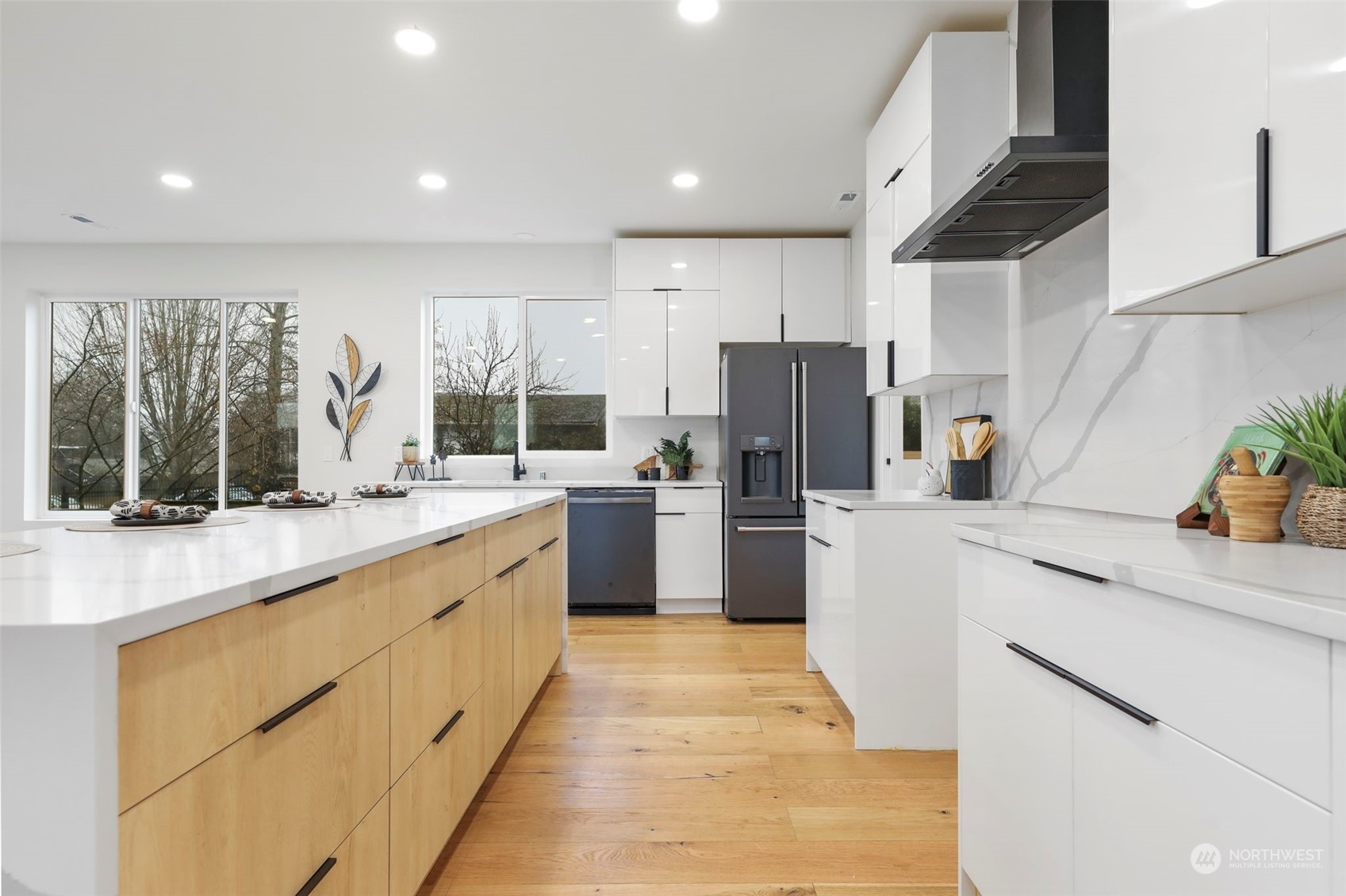 11639 Beacon Avenue South Seattle, WA 98178 - Photo 13 of 35 a kitchen with stainless steel appliances kitchen island granite countertop a refrigerator a sink dishwasher and white cabinets with wooden floor