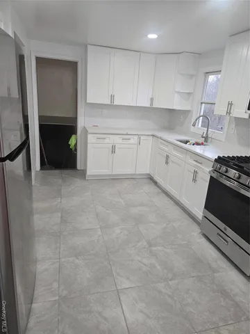 a kitchen with a sink and cabinets