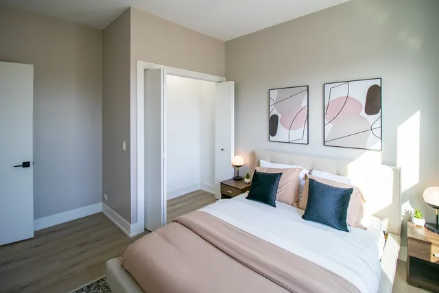 a bedroom with a bed lamp and window