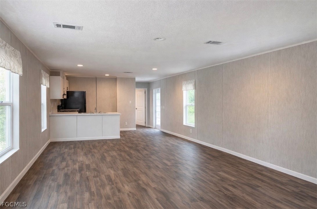 566 Avenida Del Sur Montura Ranches, FL 33440 - Photo 2 of 12 a view of kitchen with wooden floor and electronic appliances