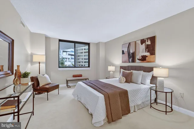 a bedroom with a bed and a large mirror