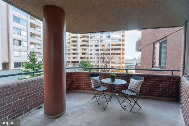 a balcony with table and chairs