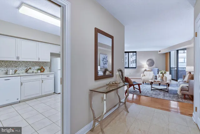 a living room with furniture and view of kitchen