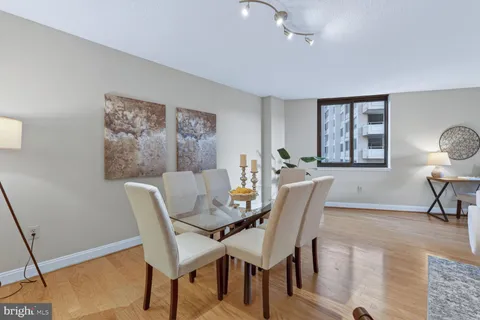 a dining room with furniture and window