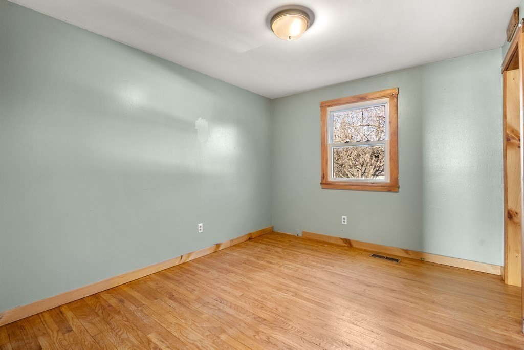 4 Meadow Lane Three Rivers, MA 01080 - Photo 18 of 23 an empty room with wooden floor and windows