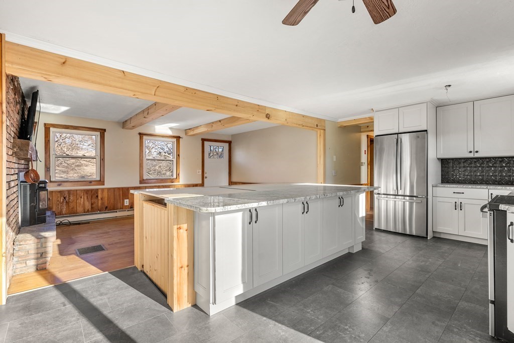 4 Meadow Lane Three Rivers, MA 01080 - Photo 5 of 23 a kitchen with white cabinets and wooden floor