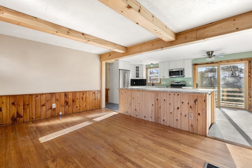 4 Meadow Lane Three Rivers, MA 01080 - Photo 9 of 23 a kitchen with stainless steel appliances kitchen island granite countertop a refrigerator a stove a sink dishwasher and white cabinets with wooden floor