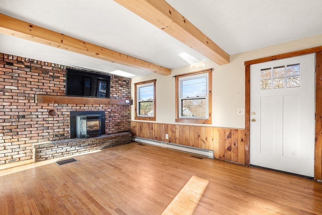 4 Meadow Lane Three Rivers, MA 01080 - Photo 10 of 23 a living room with a fireplace and a large window