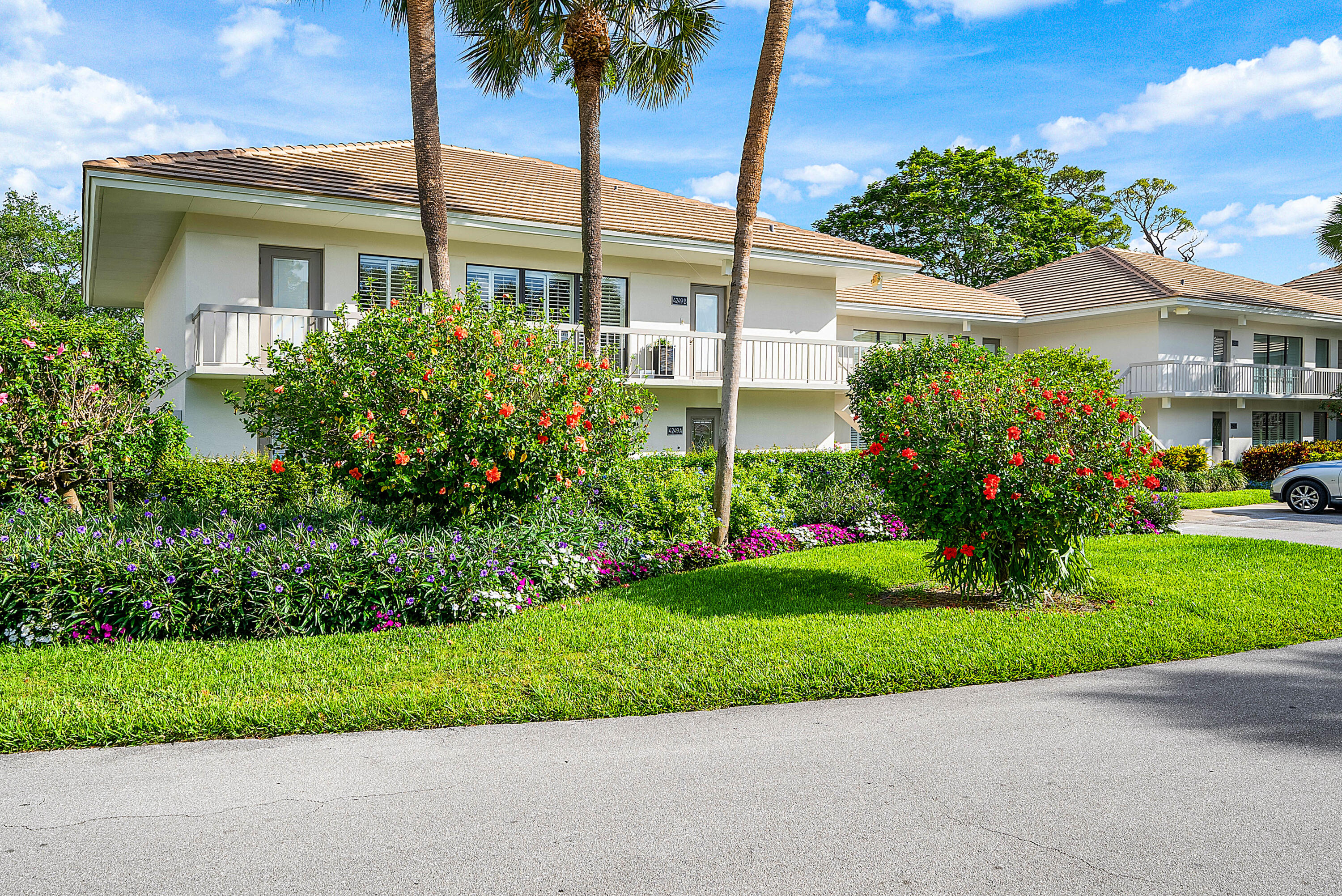 4249 North Quail Ridge Drive, Unit A Boynton Beach, FL 33436 - Photo 1 of 49 a front view of a house with a garden and yard