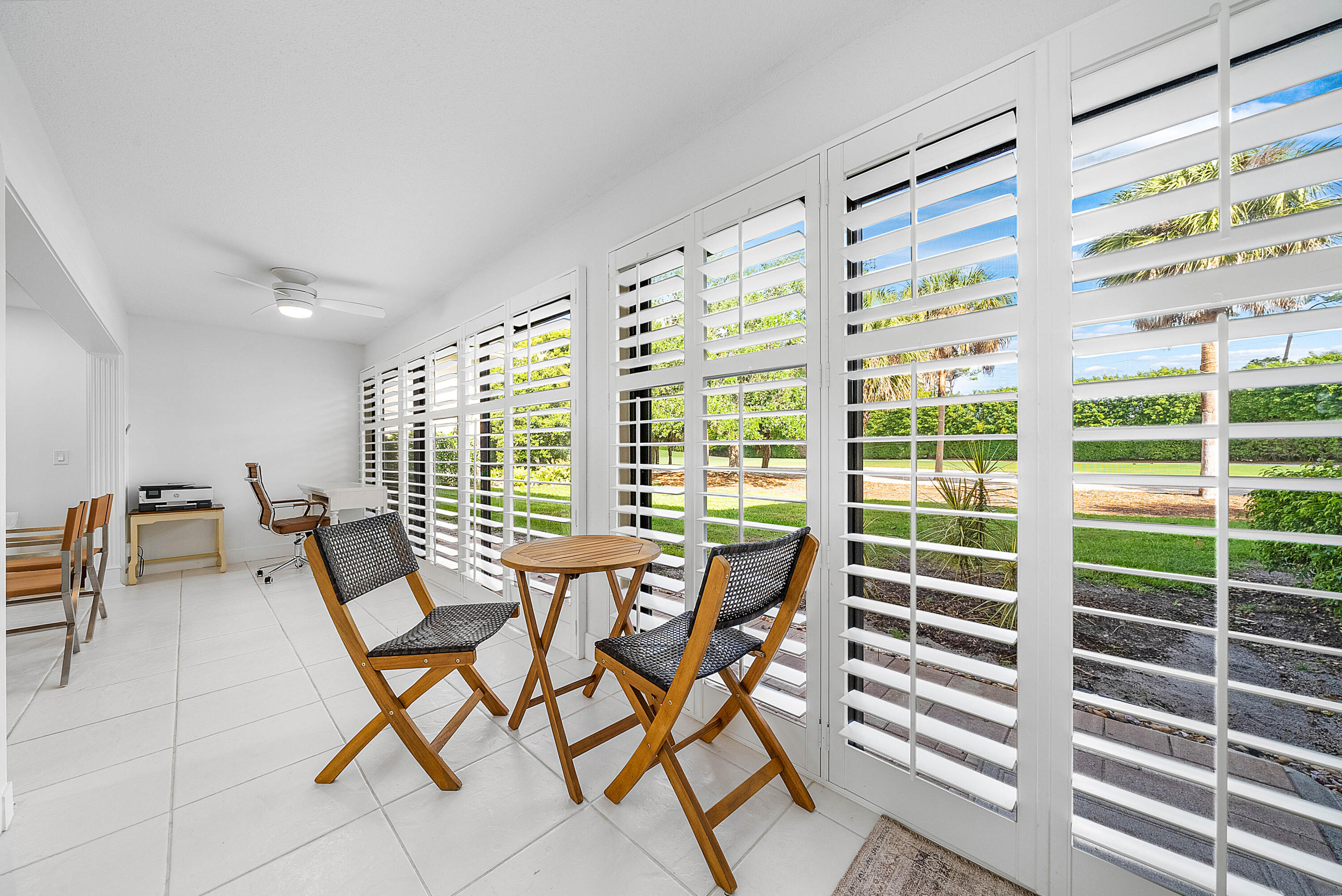 4249 North Quail Ridge Drive, Unit A Boynton Beach, FL 33436 - Photo 12 of 49 a dining room with furniture and a large window