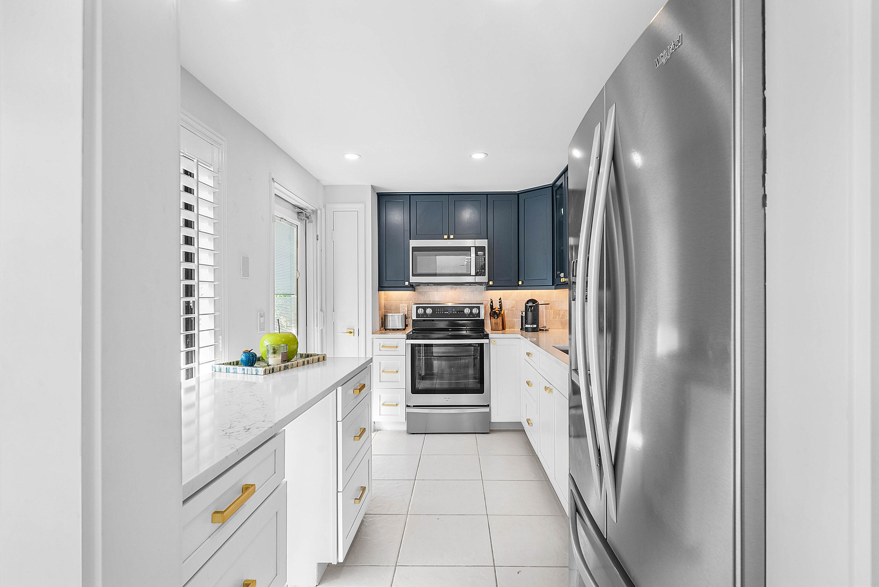 4249 North Quail Ridge Drive, Unit A Boynton Beach, FL 33436 - Photo 17 of 49 a kitchen with stainless steel appliances granite countertop a refrigerator and a stove