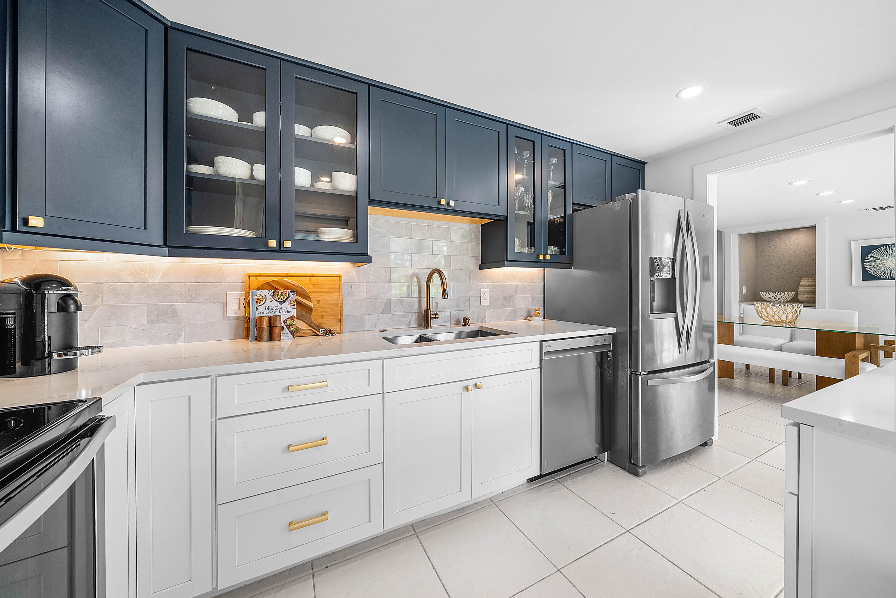 4249 North Quail Ridge Drive, Unit A Boynton Beach, FL 33436 - Photo 18 of 49 a kitchen with stainless steel appliances a refrigerator sink and cabinets
