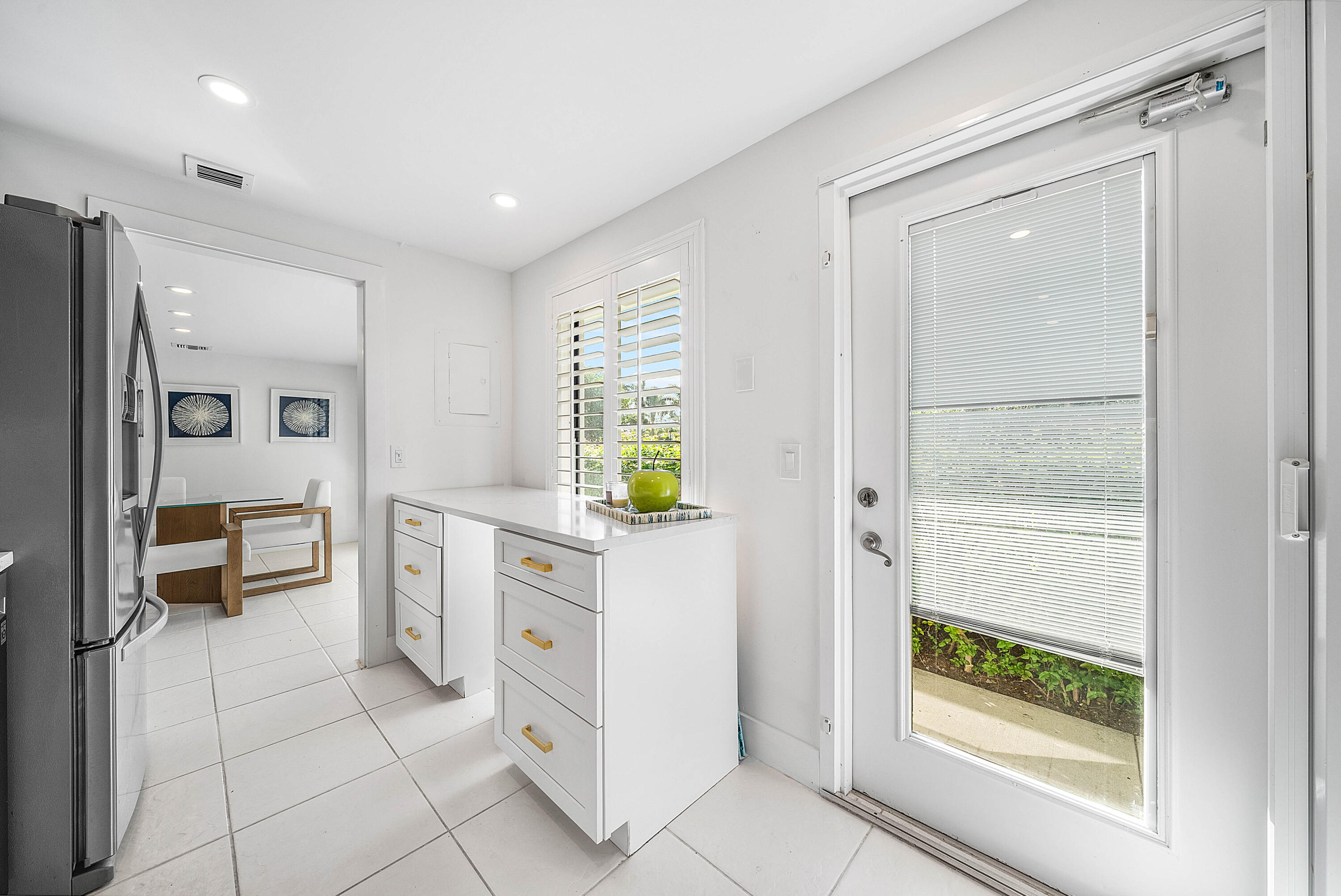4249 North Quail Ridge Drive, Unit A Boynton Beach, FL 33436 - Photo 19 of 49 a bathroom with a granite countertop sink a vanity and a mirror