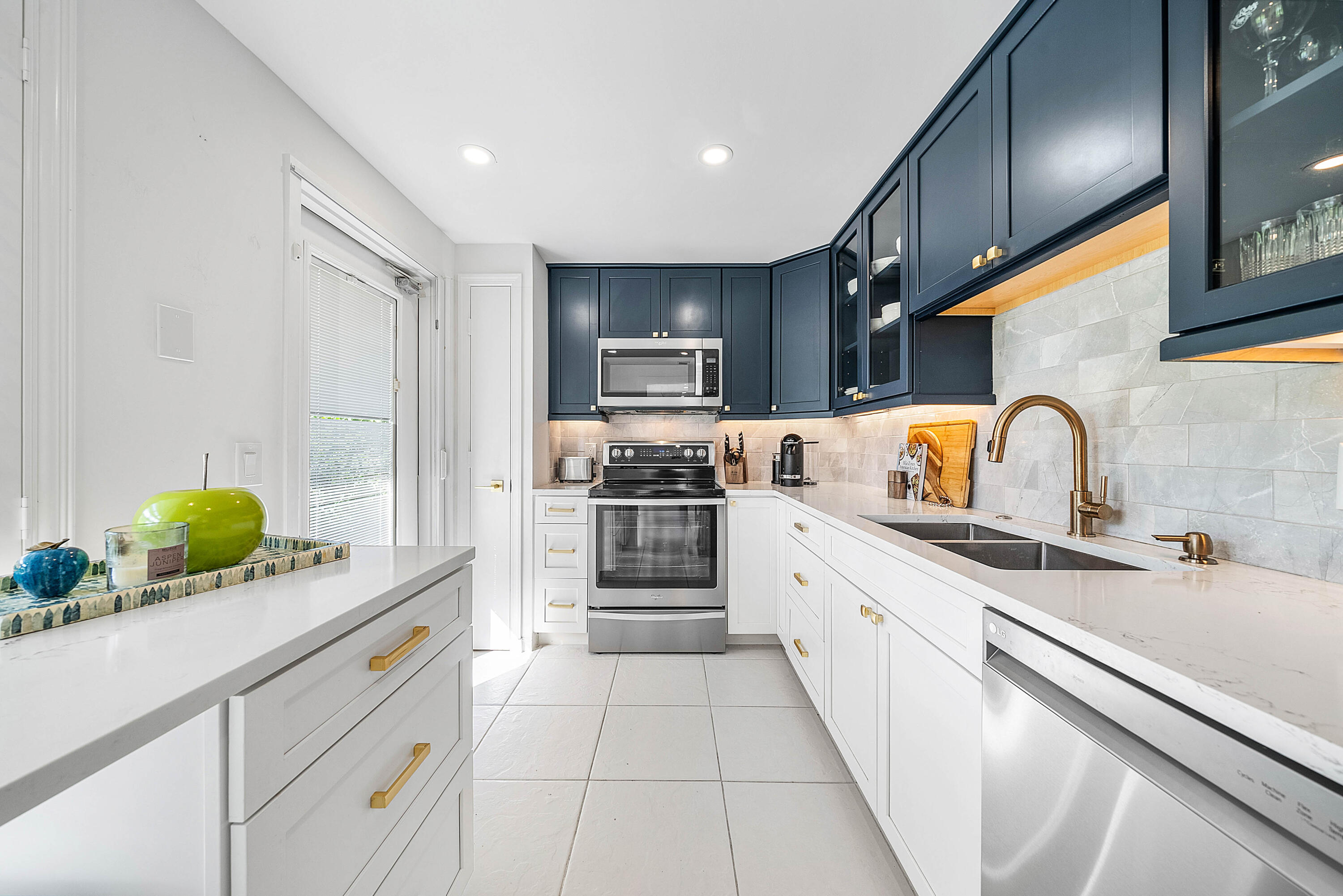 4249 North Quail Ridge Drive, Unit A Boynton Beach, FL 33436 - Photo 20 of 49 a kitchen with stainless steel appliances a sink stove and cabinets