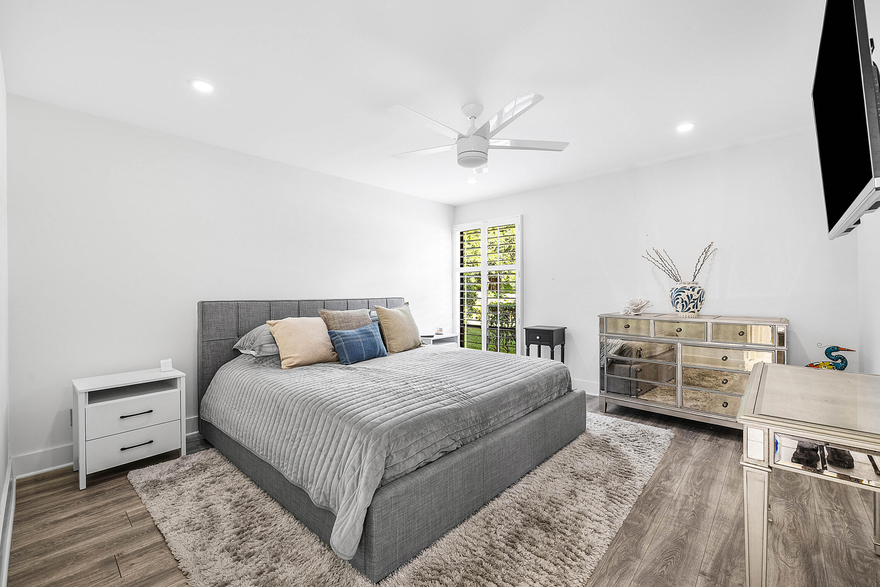 4249 North Quail Ridge Drive, Unit A Boynton Beach, FL 33436 - Photo 21 of 49 a bedroom with a bed and a flat screen tv