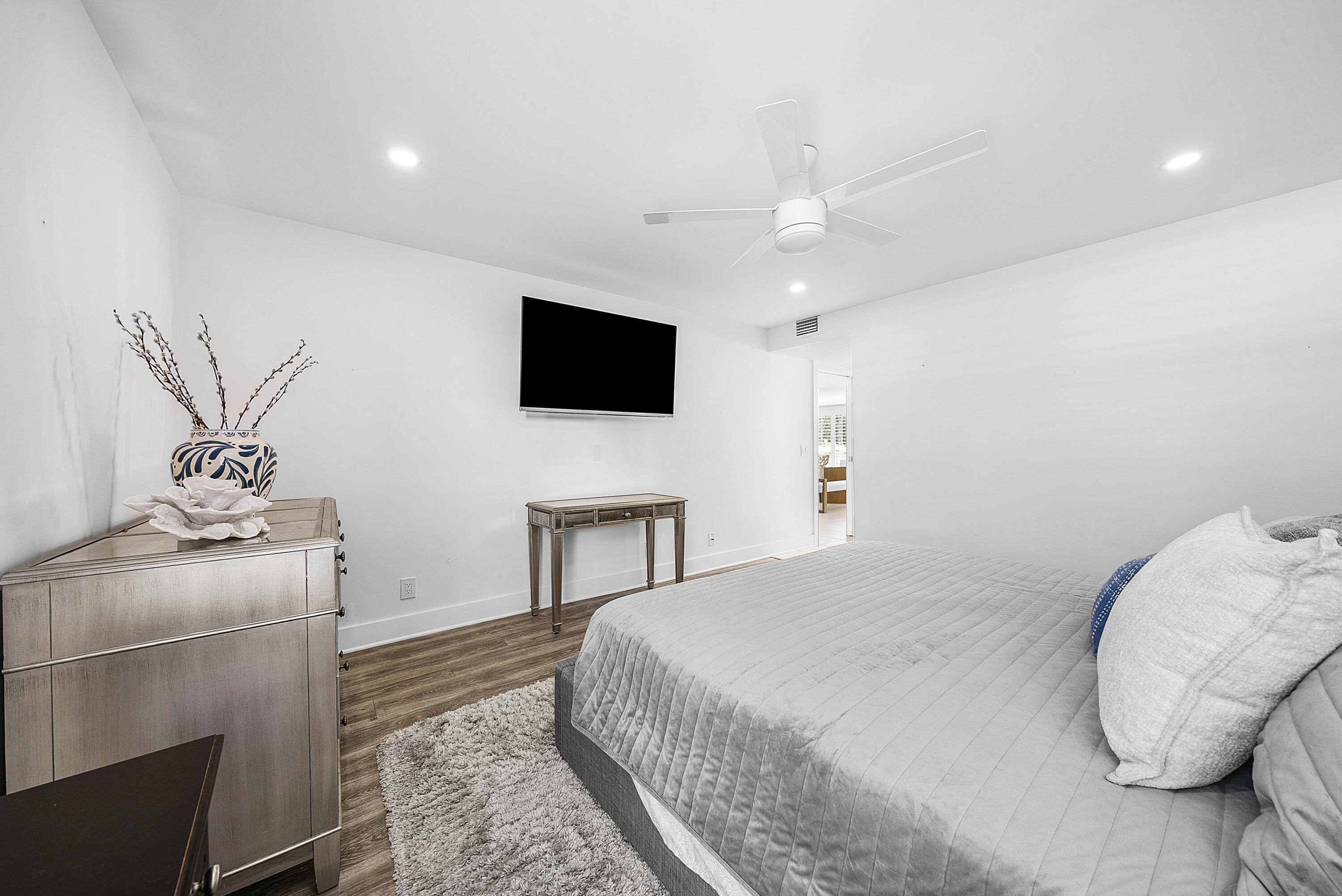4249 North Quail Ridge Drive, Unit A Boynton Beach, FL 33436 - Photo 22 of 49 a bedroom with a bed and a flat screen tv
