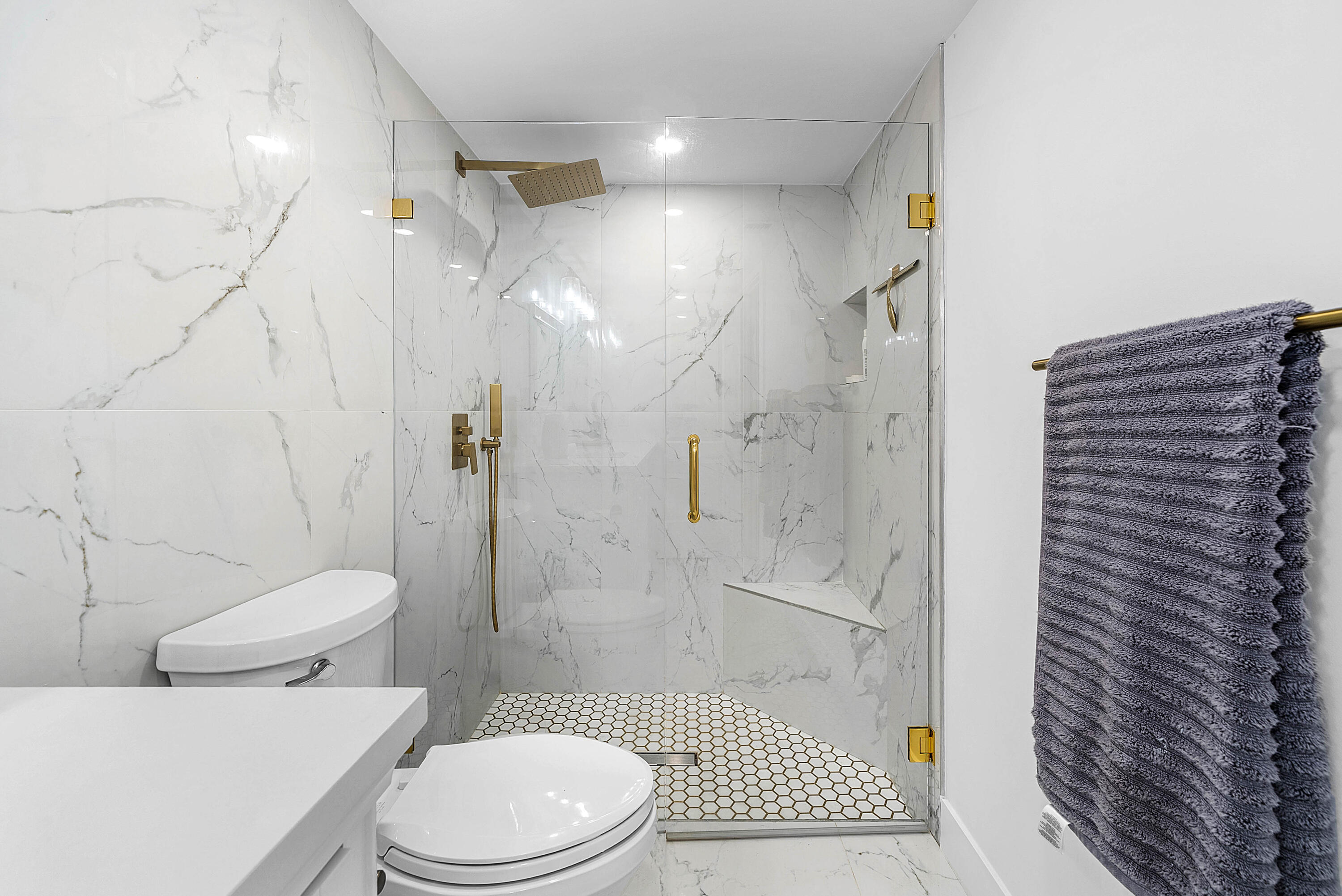 4249 North Quail Ridge Drive, Unit A Boynton Beach, FL 33436 - Photo 24 of 49 a white toilet sitting next to a bathroom sink