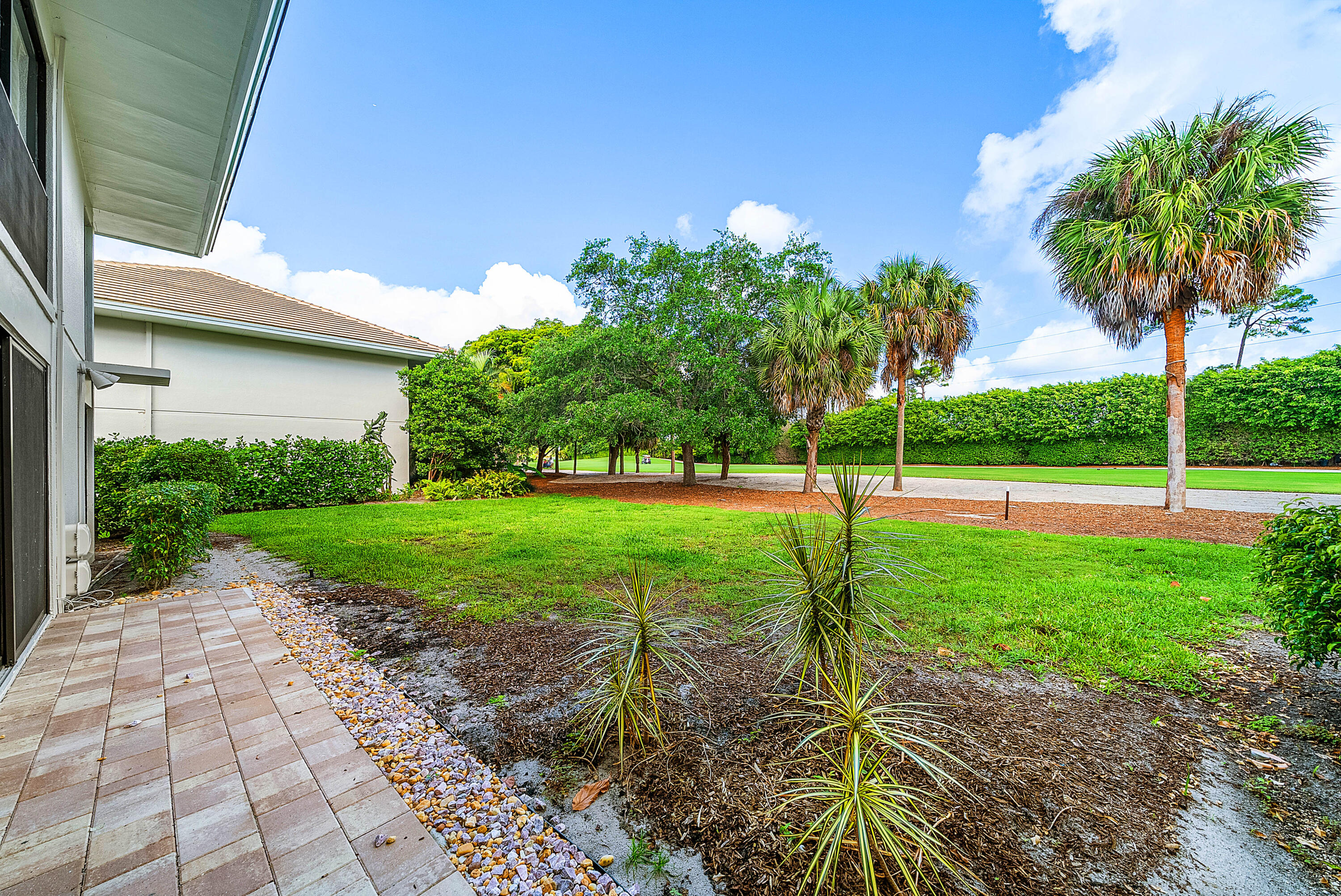 4249 North Quail Ridge Drive, Unit A Boynton Beach, FL 33436 - Photo 31 of 49 a view of a garden with a tree