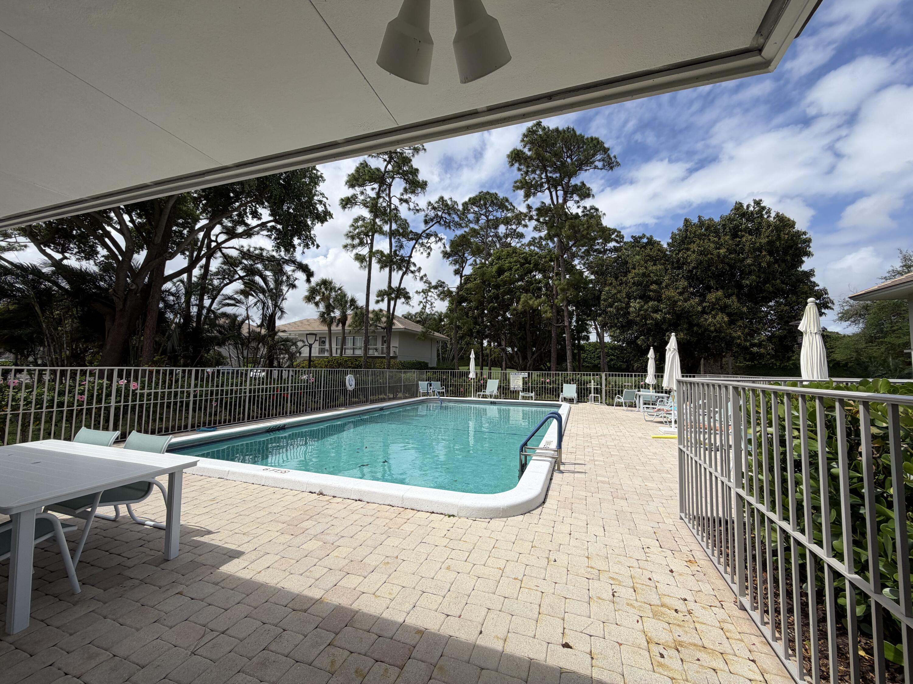 4249 North Quail Ridge Drive, Unit A Boynton Beach, FL 33436 - Photo 34 of 49 a view of a swimming pool with a patio