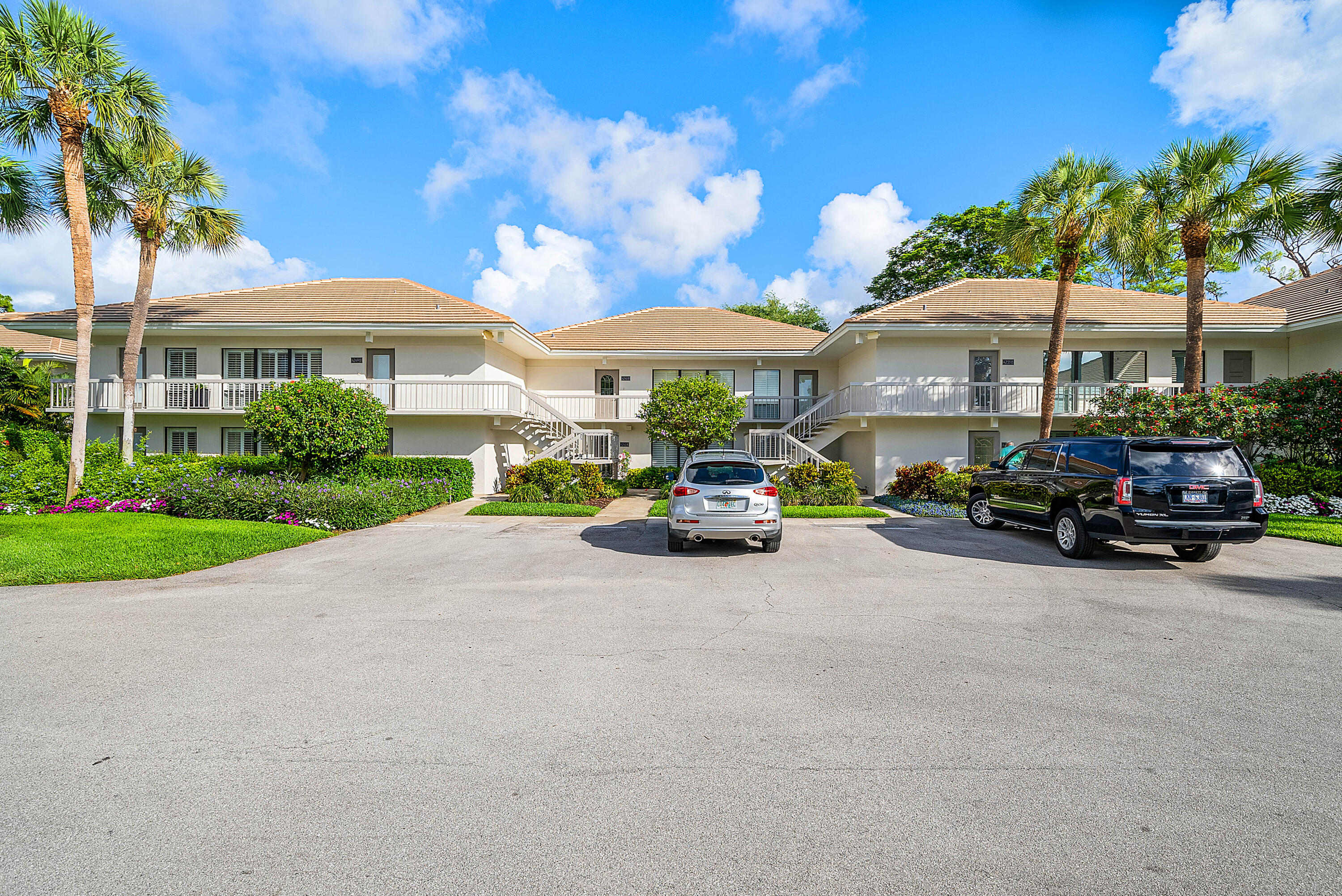 4249 North Quail Ridge Drive, Unit A Boynton Beach, FL 33436 - Photo 4 of 49 a car parked in front of a white house