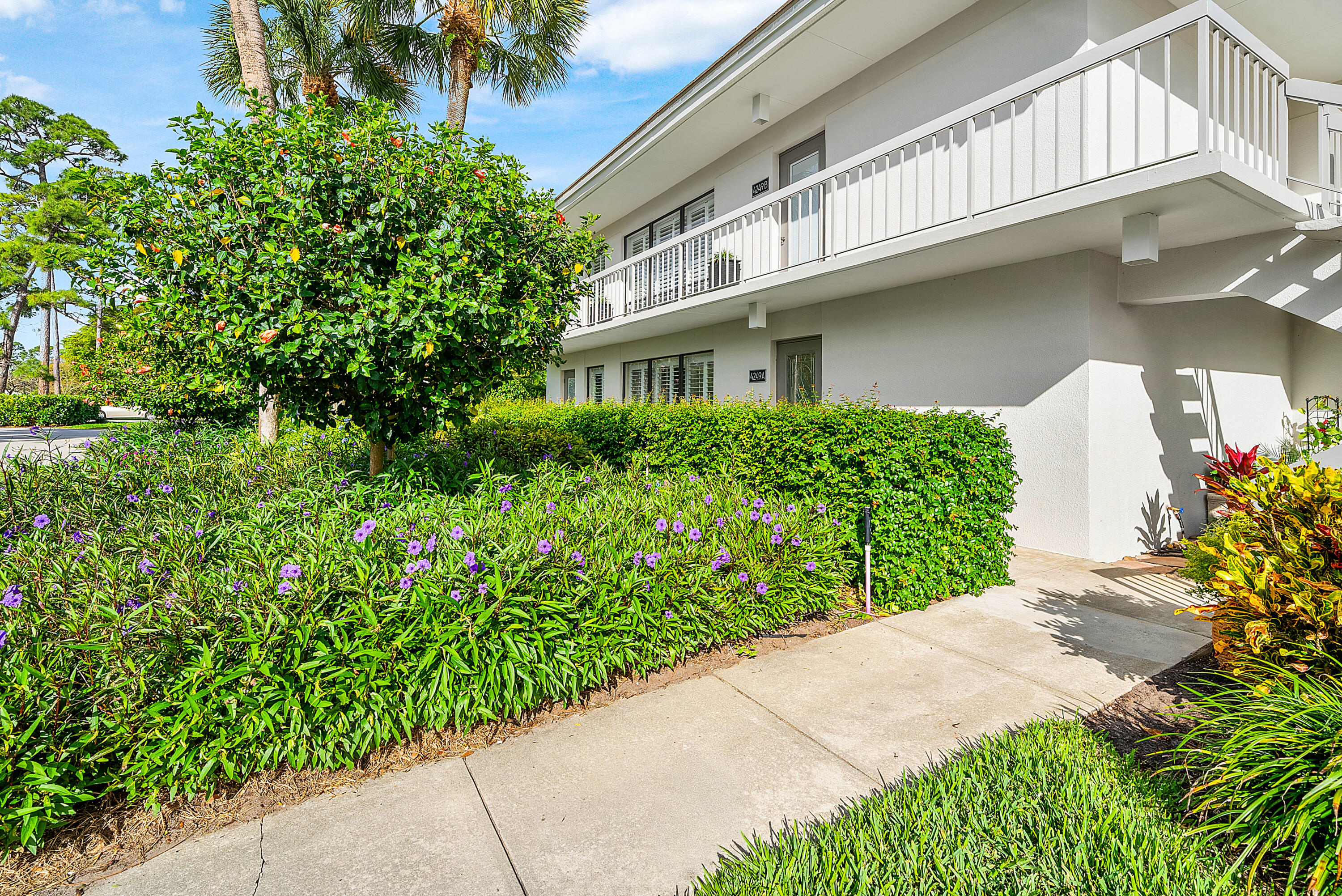 4249 North Quail Ridge Drive, Unit A Boynton Beach, FL 33436 - Photo 5 of 49 a front view of a house with garden