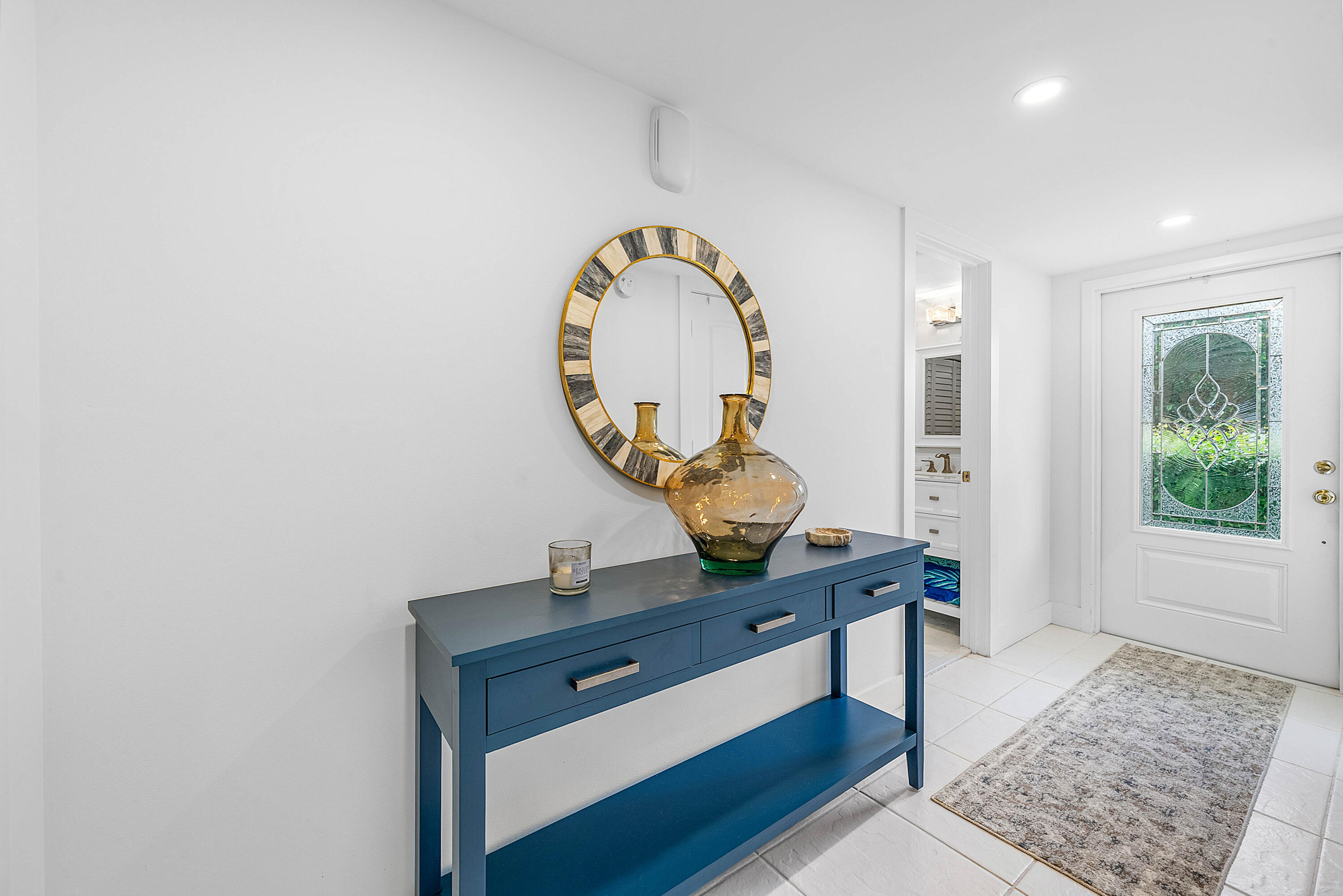 4249 North Quail Ridge Drive, Unit A Boynton Beach, FL 33436 - Photo 6 of 49 a view of a hallway with entryway wooden floor and a rug