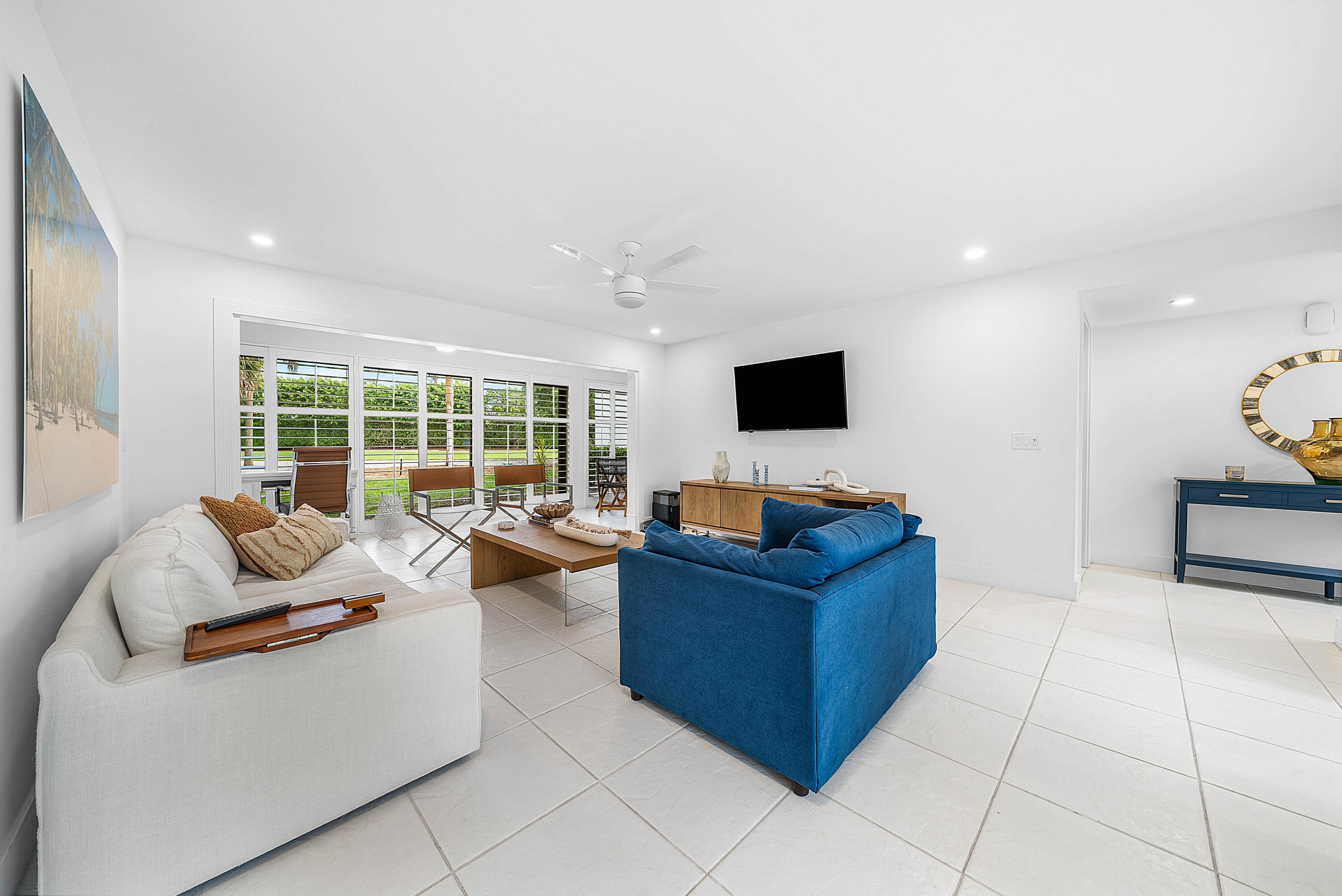 4249 North Quail Ridge Drive, Unit A Boynton Beach, FL 33436 - Photo 8 of 49 a living room with furniture and a flat screen tv