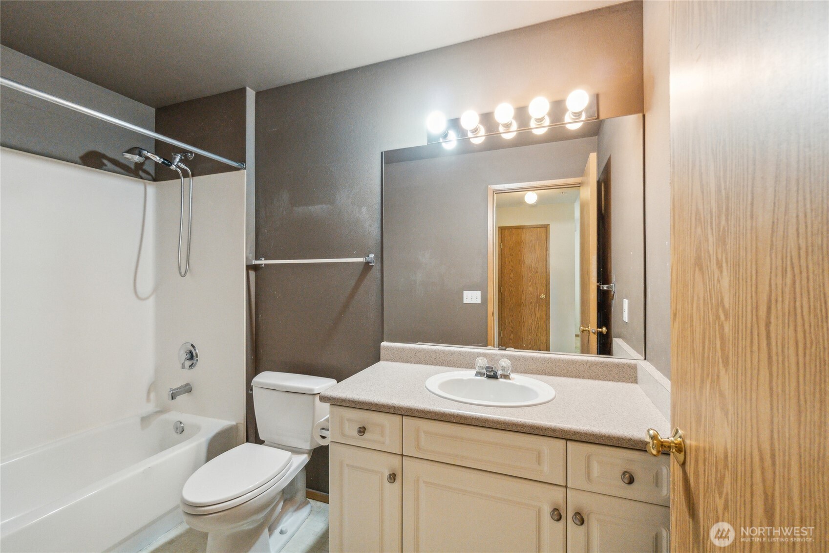 15150 140th Way Southeast, Unit T304 Renton, WA 98058 - Photo 16 of 30 a bathroom with a sink a toilet a mirror a bathtub and shower