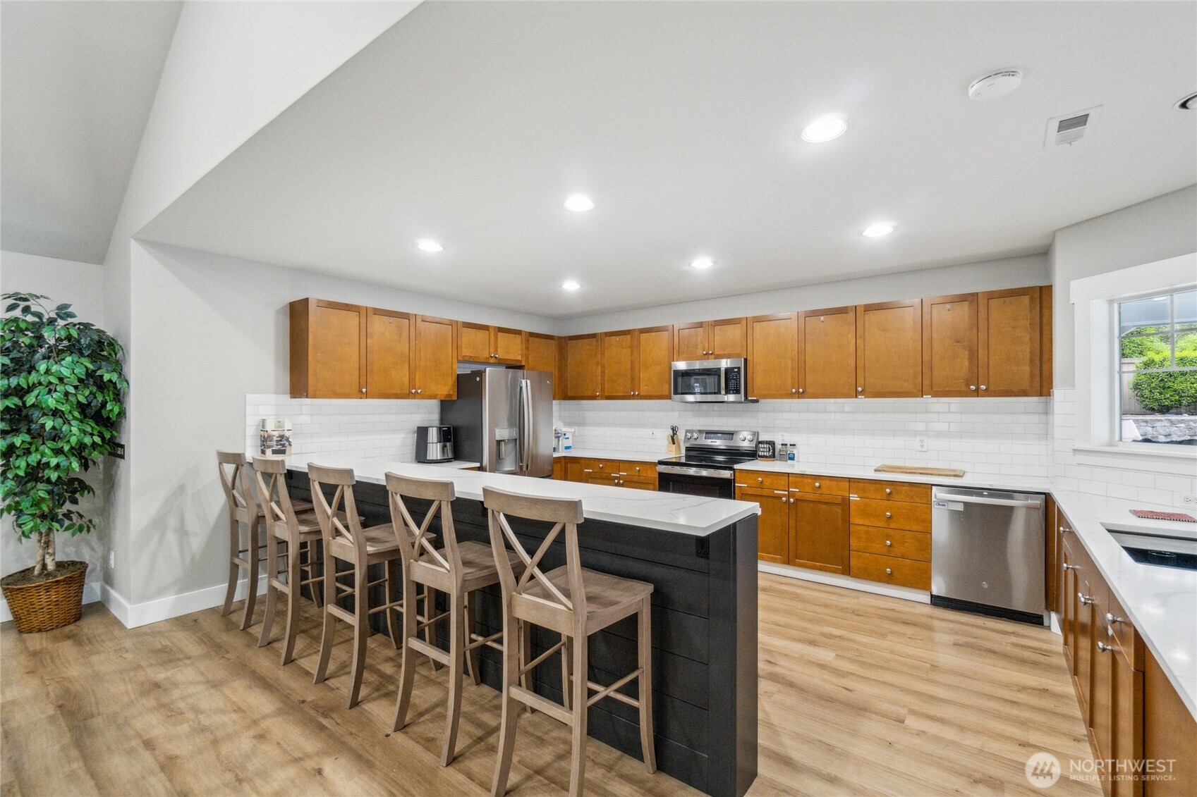 15150 140th Way Southeast, Unit T304 Renton, WA 98058 - Photo 21 of 30 a kitchen with stainless steel appliances a table and chairs in it