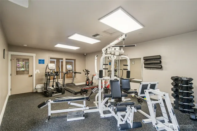 a dining hall with stainless steel appliances granite countertop a stove and a sink