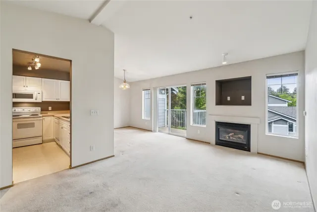 an empty room with furniture and a fireplace