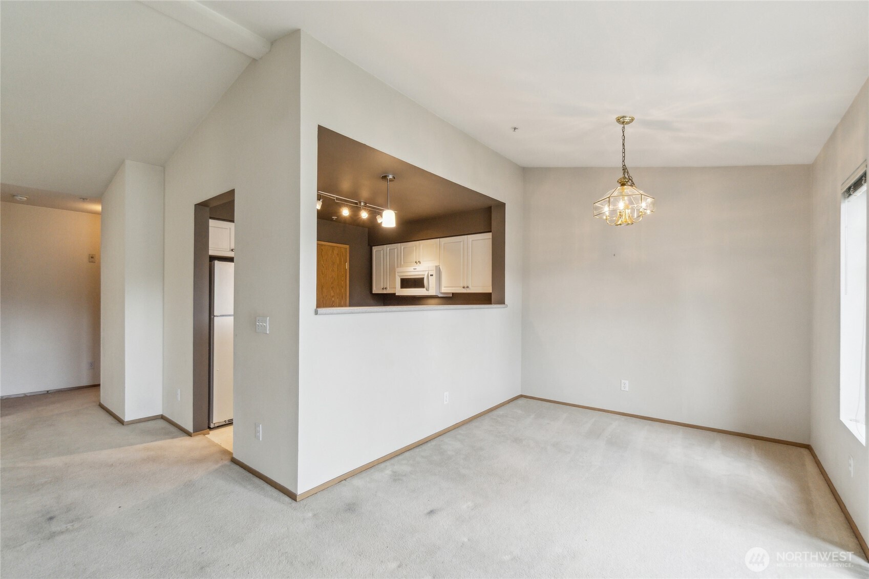 15150 140th Way Southeast, Unit T304 Renton, WA 98058 - Photo 6 of 30 an empty room with chandelier and windows