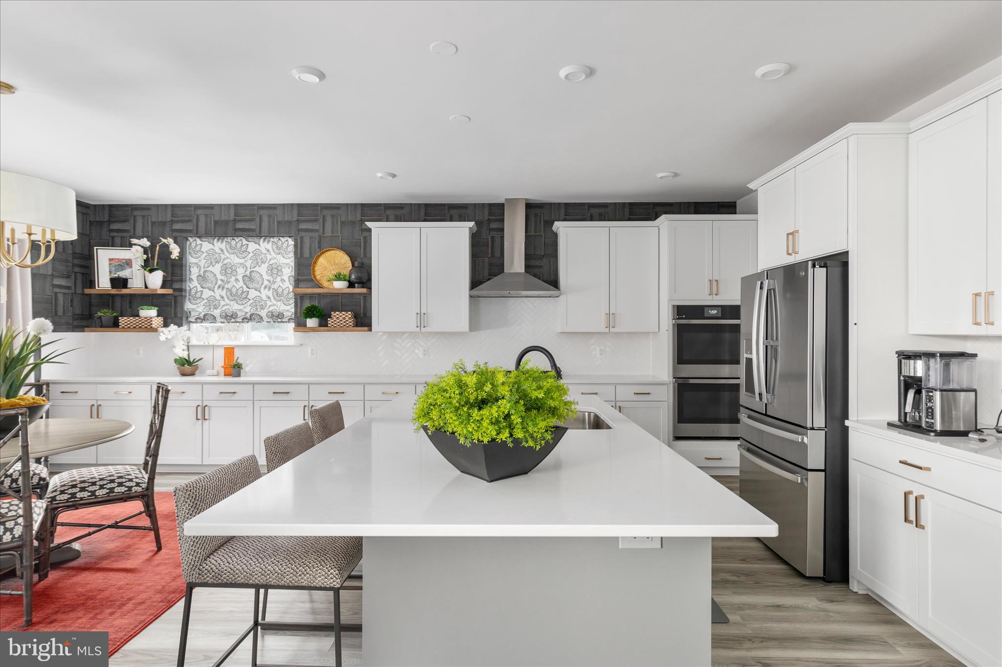 174 Williamson Road Winchester, VA 22602 - Photo 14 of 67 a kitchen with stainless steel appliances kitchen island granite countertop a refrigerator a sink dishwasher a dining table and chairs with wooden floor
