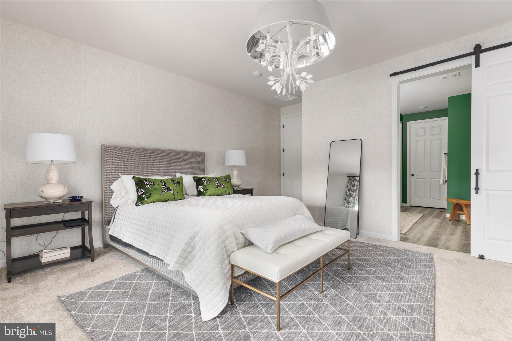 174 Williamson Road Winchester, VA 22602 - Photo 20 of 67 a spacious bedroom with a bed and a chandelier