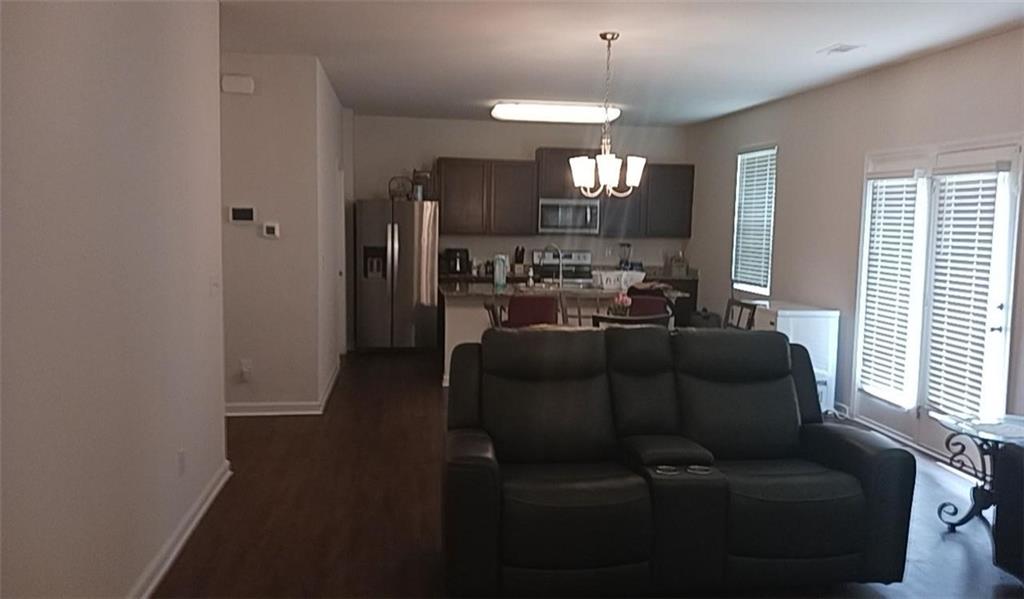 1033 Eldon Lane Fairburn, GA 30213 - Photo 7 of 21 a living room with furniture and a chandelier