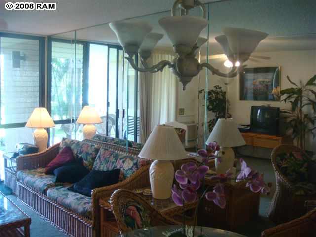 2695 South Kihei Road, Unit 10103 Kihei, HI 96753 - Photo 6 of 8 a living room filled with furniture and a chandelier